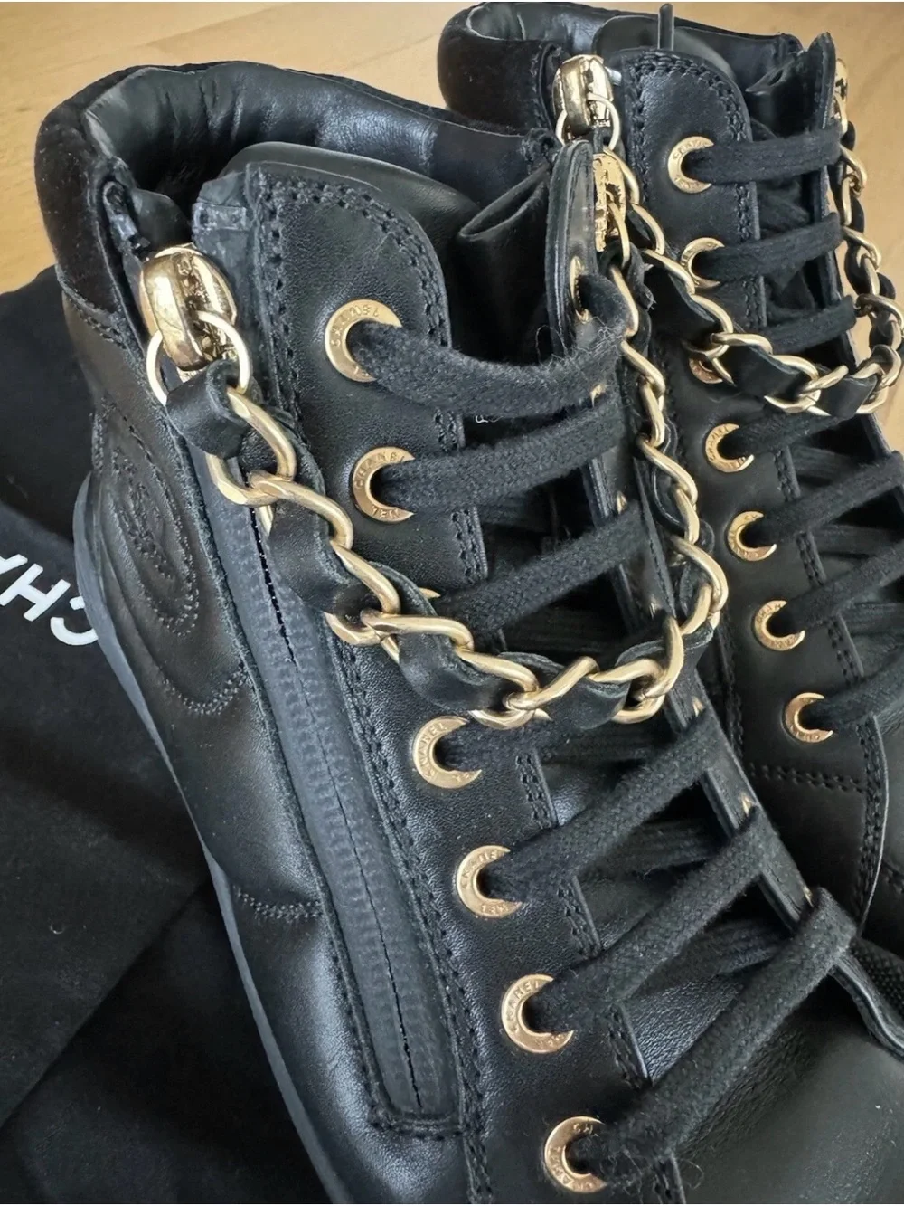 CHANEL Black Quilted High-Top Leather Sneakers with Gold Hardware